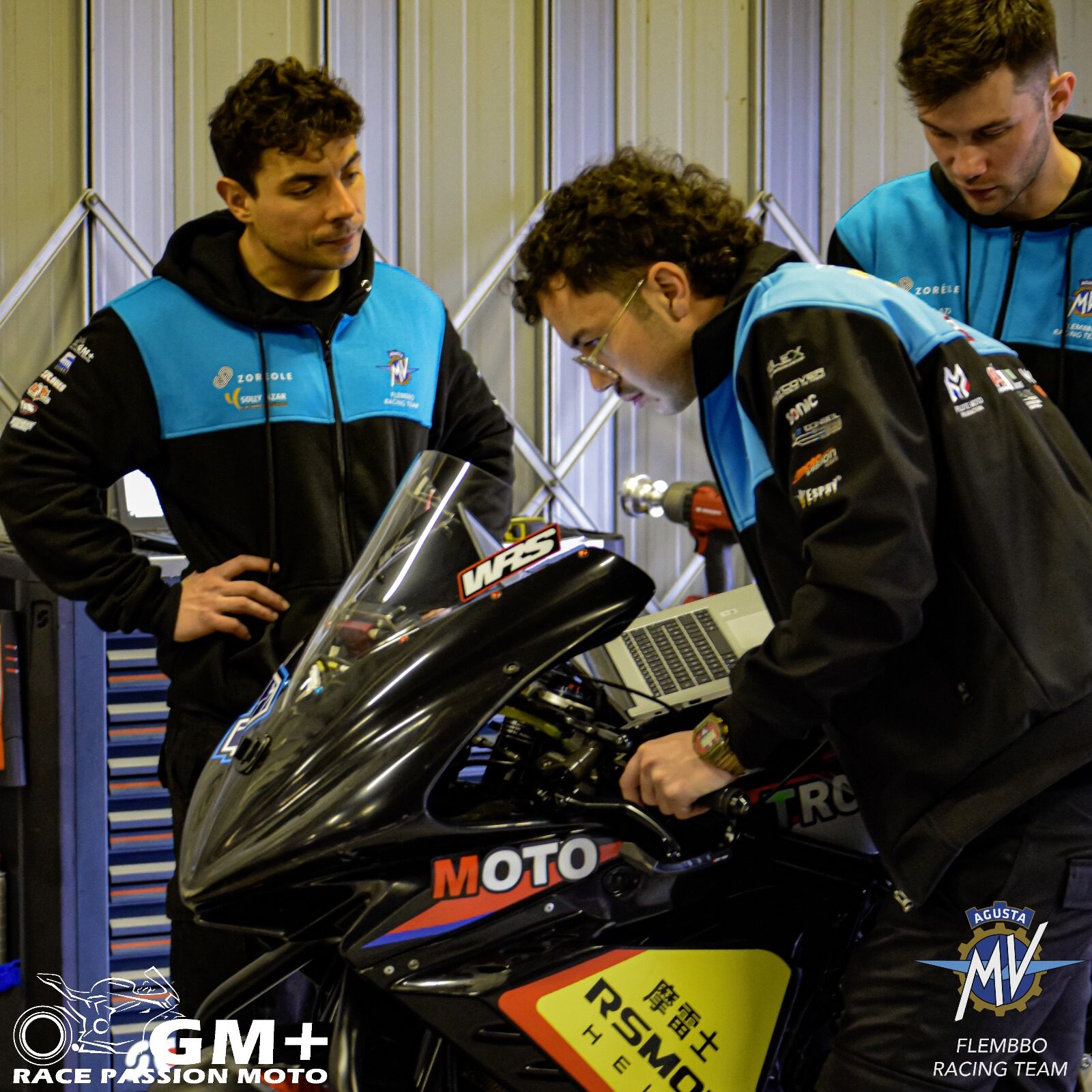 MOTO-TRON Racing technicians working with a race motorcycle in the paddock